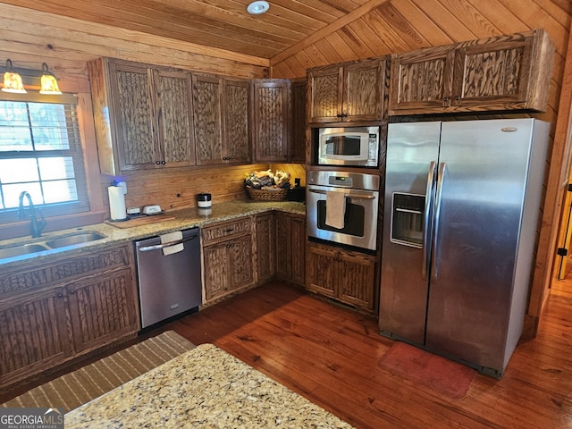 kitchen featuring wooden ceiling, sink, stainless steel appliances, and light stone counters