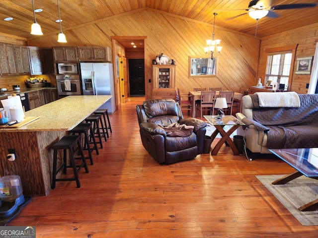 living room with lofted ceiling, wooden ceiling, wood walls, and wood-type flooring