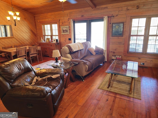 living room with hardwood / wood-style floors, wood walls, and wood ceiling