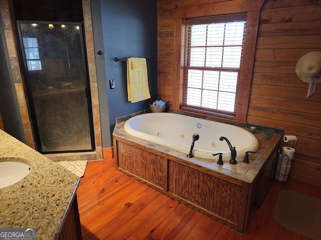 bathroom with vanity, independent shower and bath, and wood-type flooring