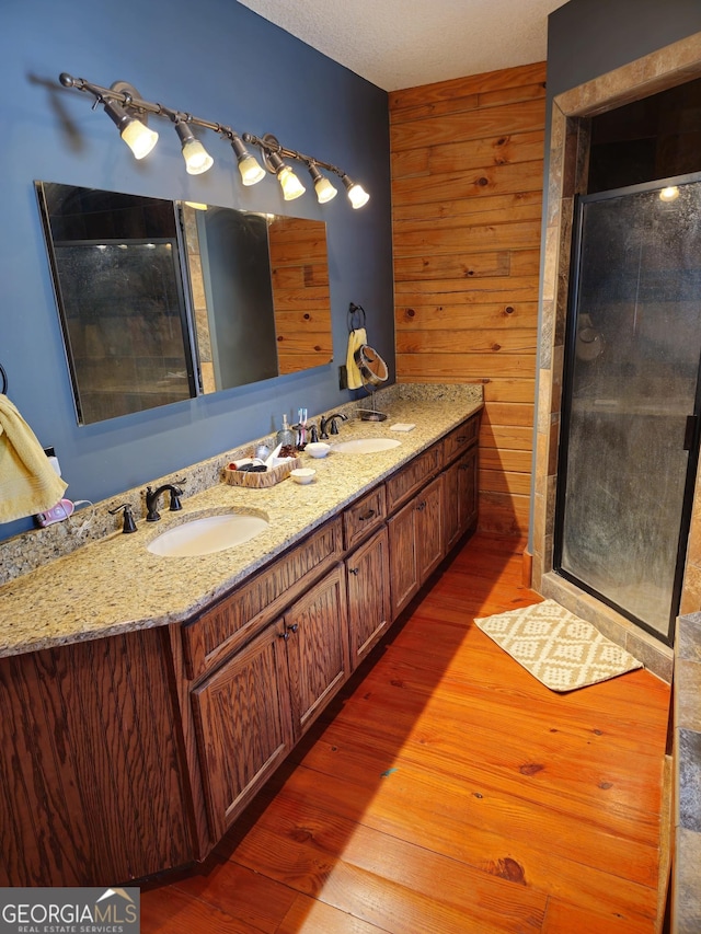 bathroom featuring vanity, a shower with door, and hardwood / wood-style floors