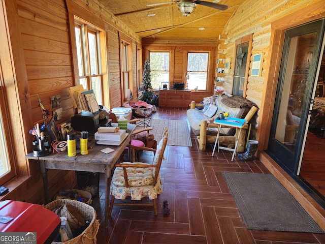 sunroom / solarium featuring lofted ceiling, ceiling fan, and wood ceiling