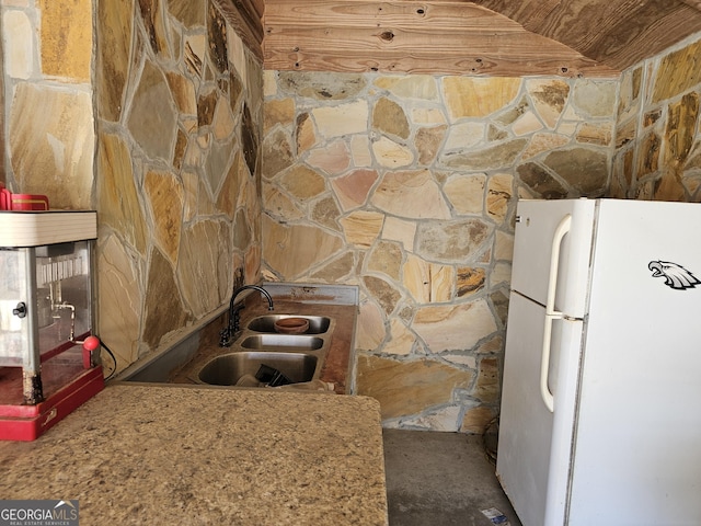 kitchen featuring white refrigerator and sink