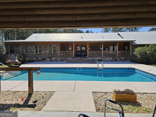 view of swimming pool featuring french doors