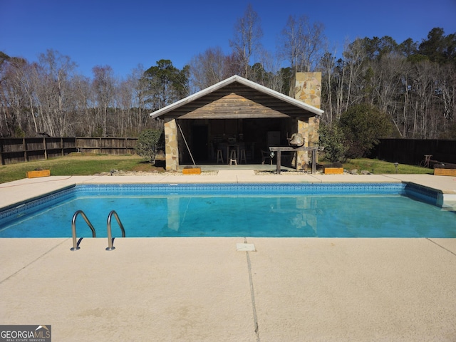 view of pool with a yard