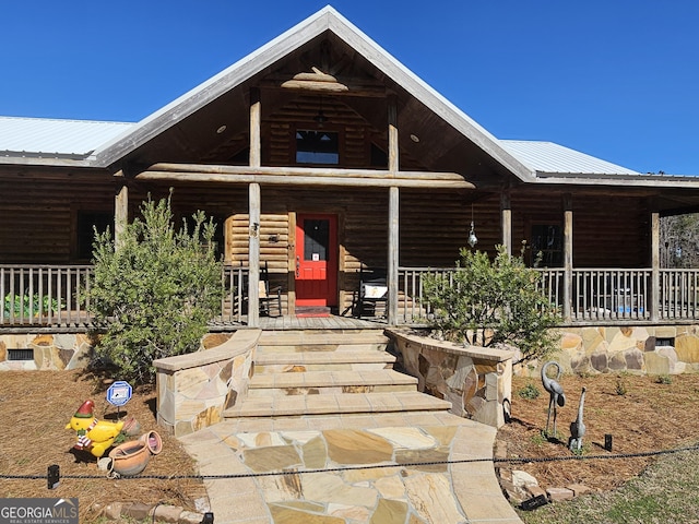 log-style house with a porch