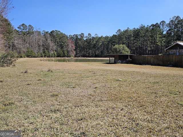 view of community featuring a water view and a lawn