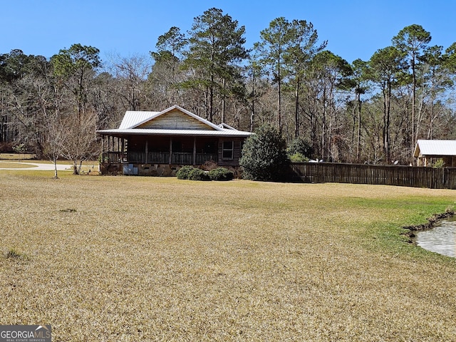 exterior space with covered porch and a yard