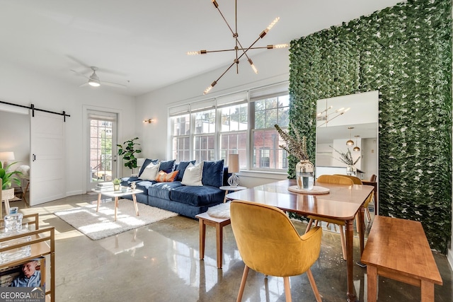 living room with concrete flooring, a barn door, and ceiling fan with notable chandelier