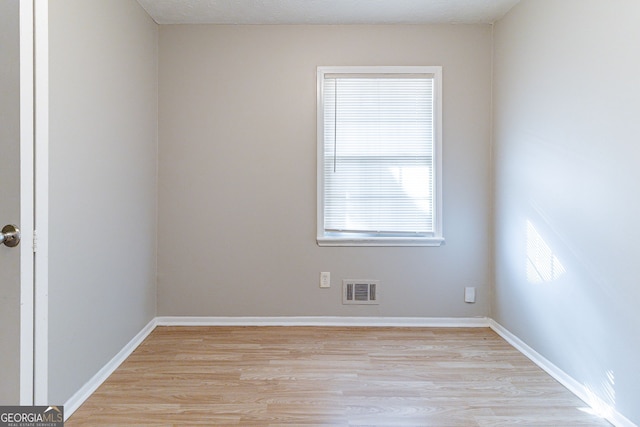spare room featuring light hardwood / wood-style floors
