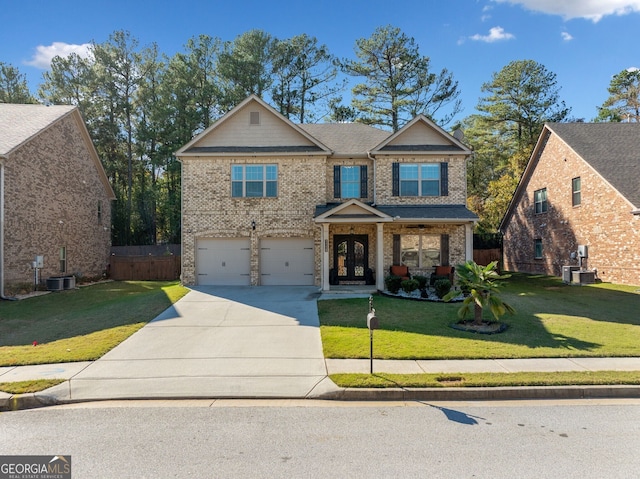 1118 Reddy Farm Rd, Grayson, GA 30017 - view of front of house featuring central AC, a front yard, and a garage