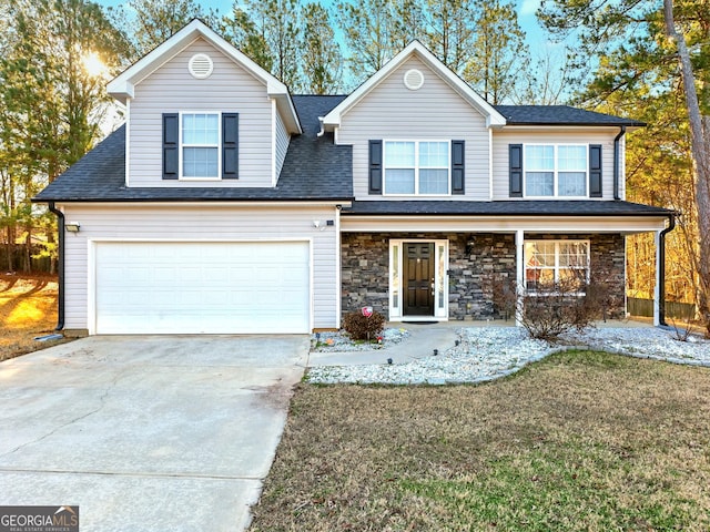 front of property with covered porch, a front yard, and a garage