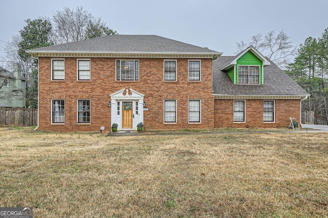 colonial home with a front lawn