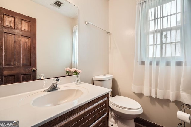 bathroom featuring toilet and vanity