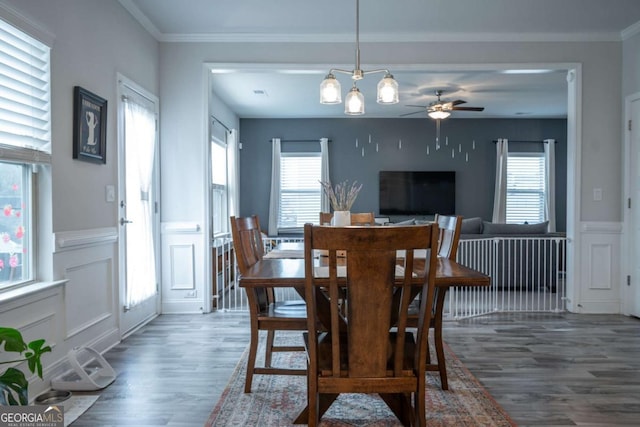 dining area featuring a wealth of natural light, dark hardwood / wood-style floors, and ornamental molding