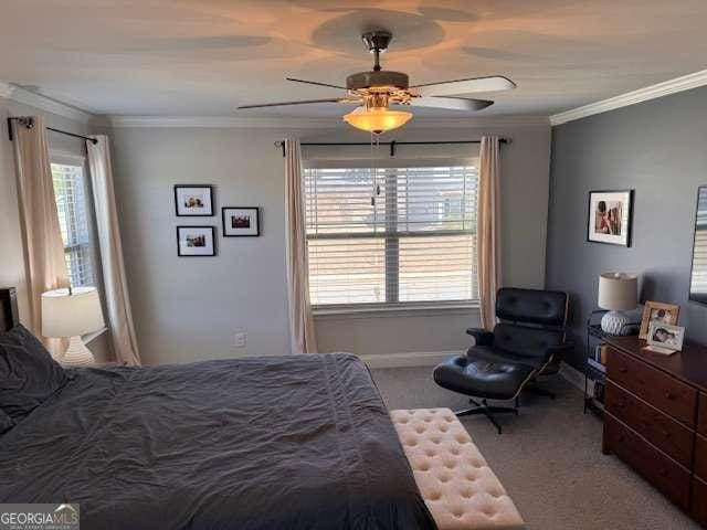 bedroom with ceiling fan, ornamental molding, and carpet