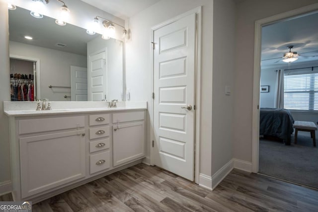 bathroom with hardwood / wood-style flooring, vanity, and ceiling fan