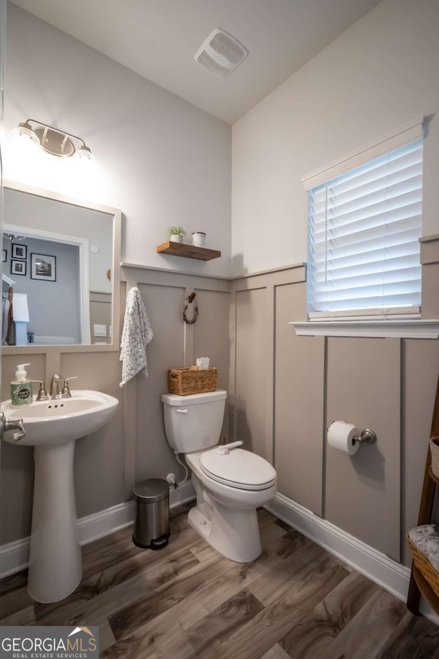 bathroom featuring hardwood / wood-style flooring, sink, and toilet