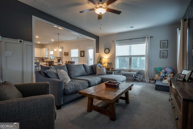 living room featuring light carpet and ceiling fan