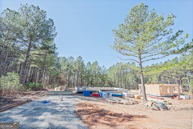 exterior space featuring a wooded view