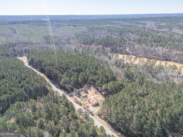 bird's eye view with a wooded view