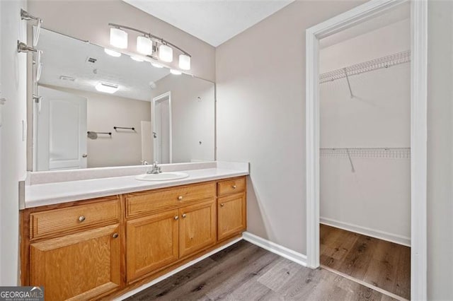 bathroom featuring vanity and hardwood / wood-style floors