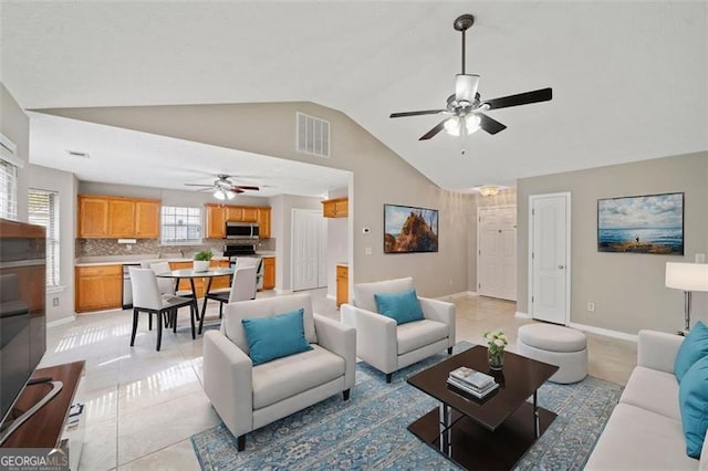 tiled living room featuring lofted ceiling and ceiling fan