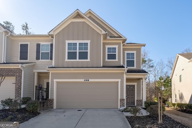 view of front of home with board and batten siding, brick siding, driveway, and an attached garage