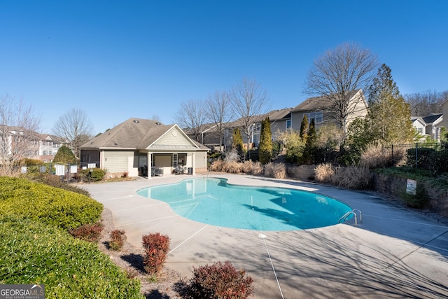 view of swimming pool with fence, a fenced in pool, and a patio