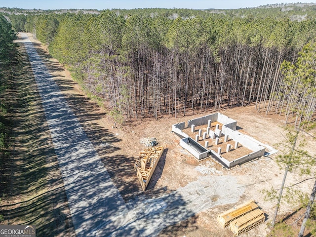 drone / aerial view with a wooded view