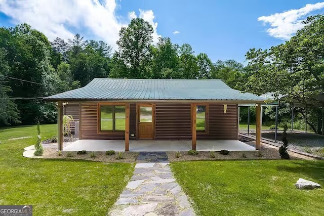 exterior space featuring a patio and a front lawn