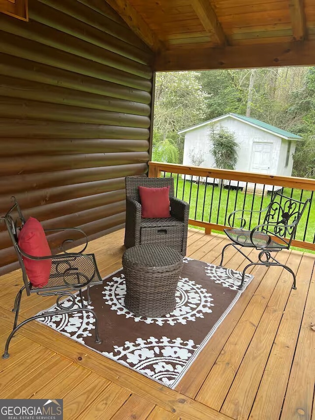 wooden deck featuring a shed