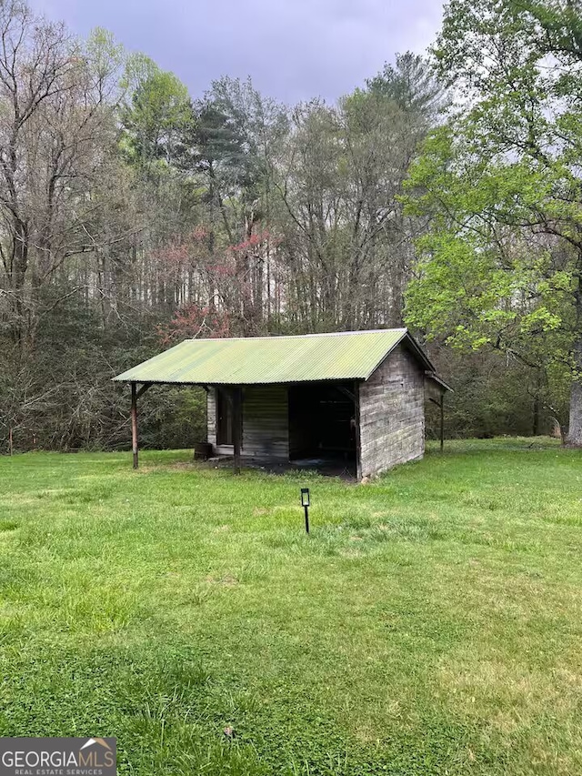 view of outbuilding with a yard