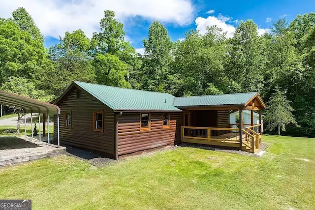 view of outbuilding featuring a yard and a carport