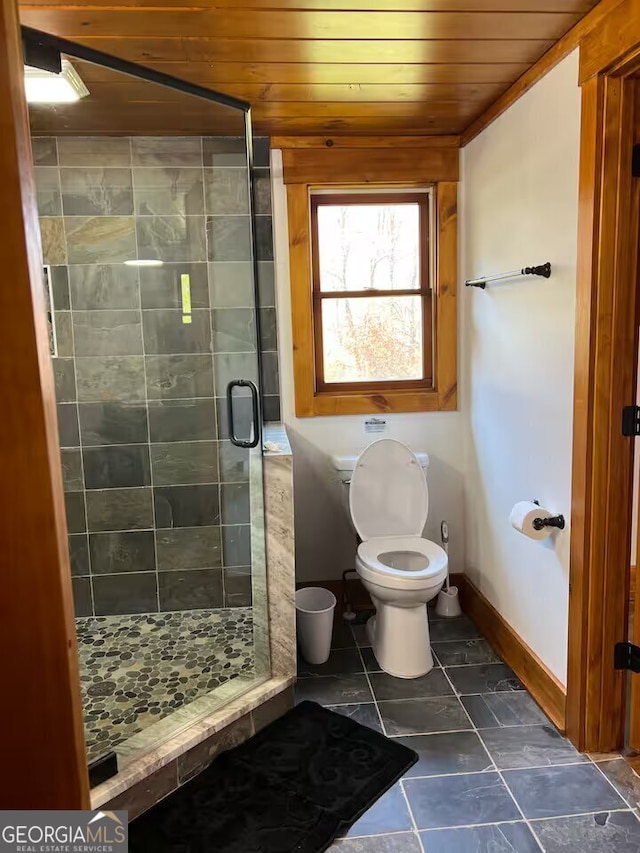 bathroom with wooden ceiling, a shower with shower door, and toilet