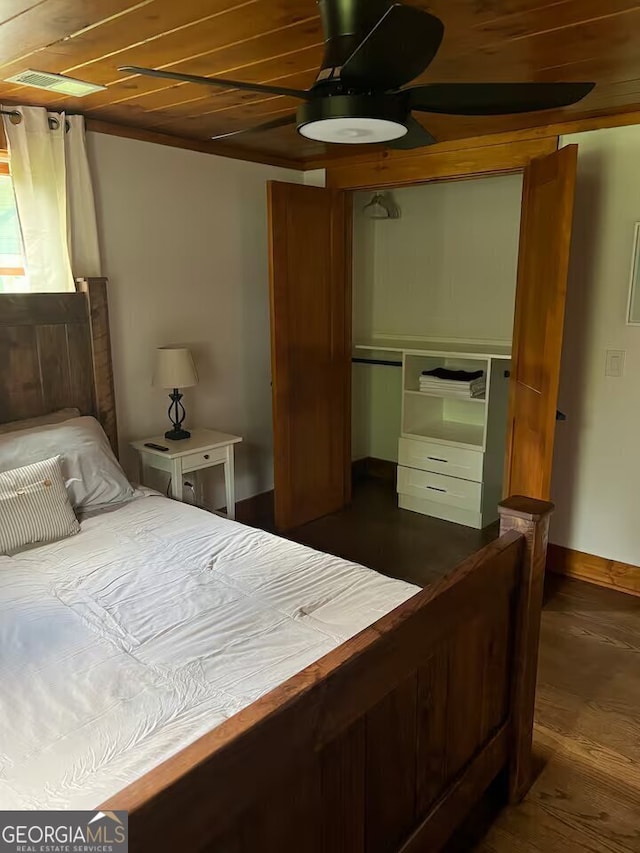 bedroom featuring a closet, ceiling fan, wood ceiling, and dark hardwood / wood-style floors