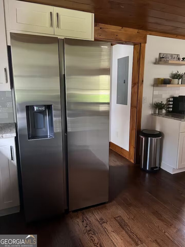 kitchen featuring white cabinets, stainless steel refrigerator with ice dispenser, electric panel, backsplash, and dark hardwood / wood-style floors