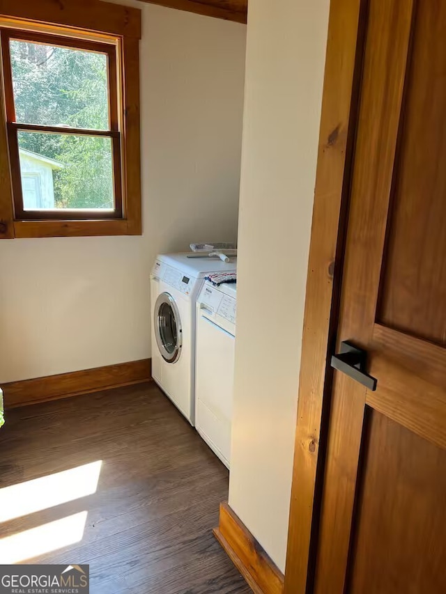 washroom with dark hardwood / wood-style flooring and washing machine and dryer