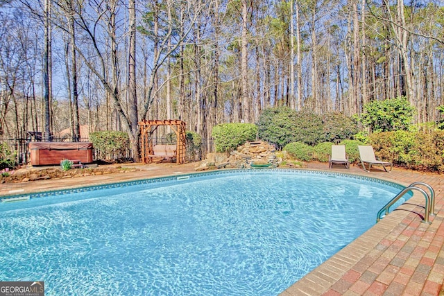 outdoor pool featuring a hot tub