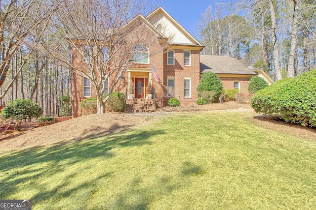 view of front of home featuring a front lawn and brick siding