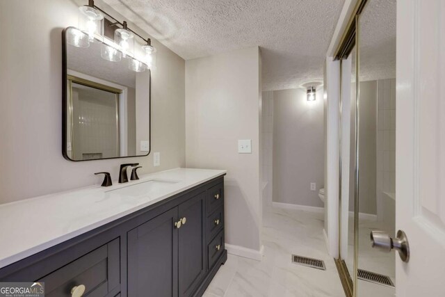 4419 New Kings Bridge Rd, Nicholson, GA 30565 - full bathroom with marble look tiles, vanity, a textured ceiling, toilet, and baseboards
