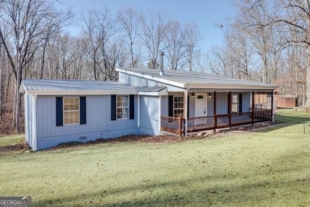 view of front of home featuring covered porch, metal roof, a front lawn, and crawl space