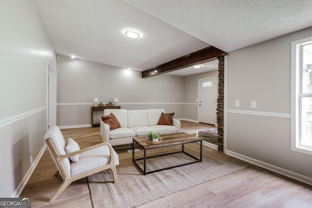 4419 New Kings Bridge Rd, Nicholson, GA 30565 - living room featuring light wood-type flooring, baseboards, decorative columns, and a textured ceiling