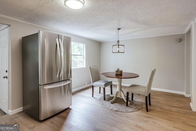 4419 New Kings Bridge Rd, Nicholson, GA 30565 - dining room with light wood-style floors, crown molding, a textured ceiling, and baseboards