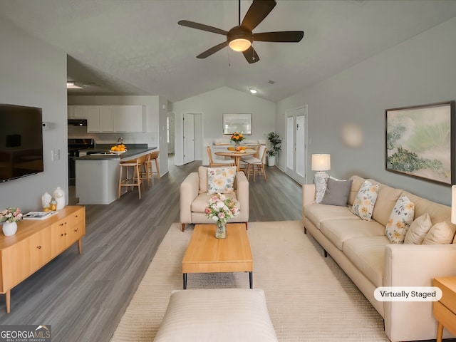 living room featuring lofted ceiling, dark hardwood / wood-style floors, and ceiling fan