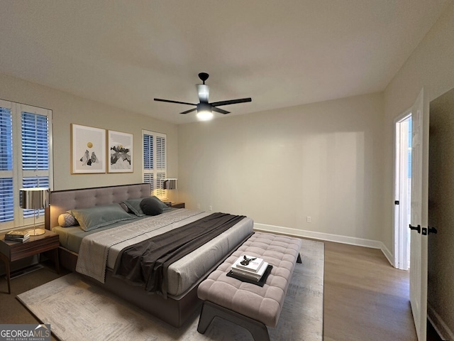 bedroom with ceiling fan and light hardwood / wood-style floors