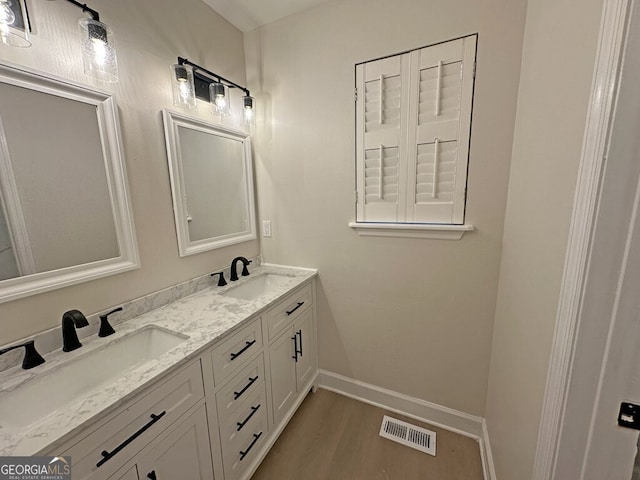 bathroom with vanity and wood-type flooring