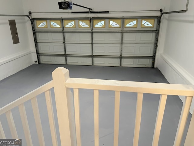 garage with electric panel and a garage door opener