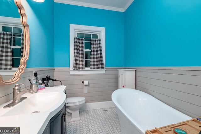 bathroom with wood walls, toilet, a bathing tub, vanity, and crown molding