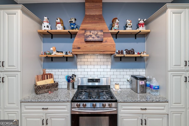 kitchen featuring white cabinetry, light stone counters, and stainless steel range with gas cooktop